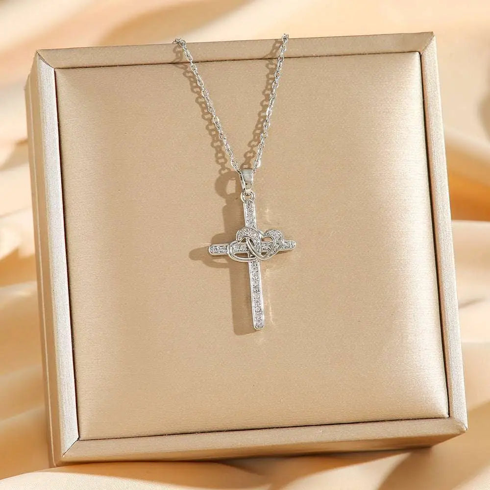 Titanium steel double cross double ring zircon pendant necklace with silver heart-shaped knot and clear crystals on beige box