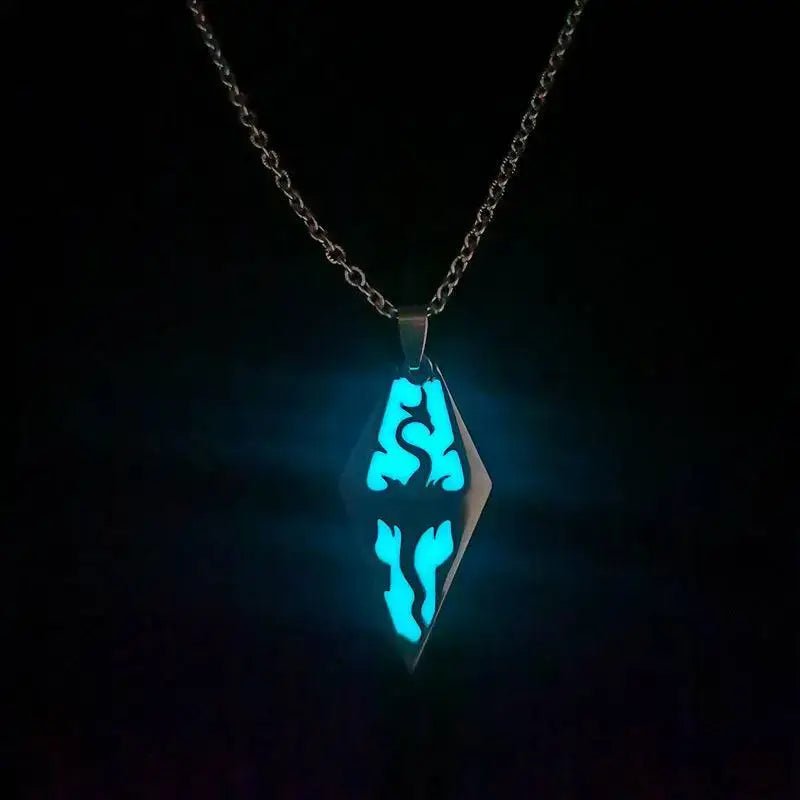 a glowing blue diamond-shaped pendant with intricate cut-out designs suspended from a titanium steel silver chain featured in royalessencelux titanium steel jewelry collection highlights