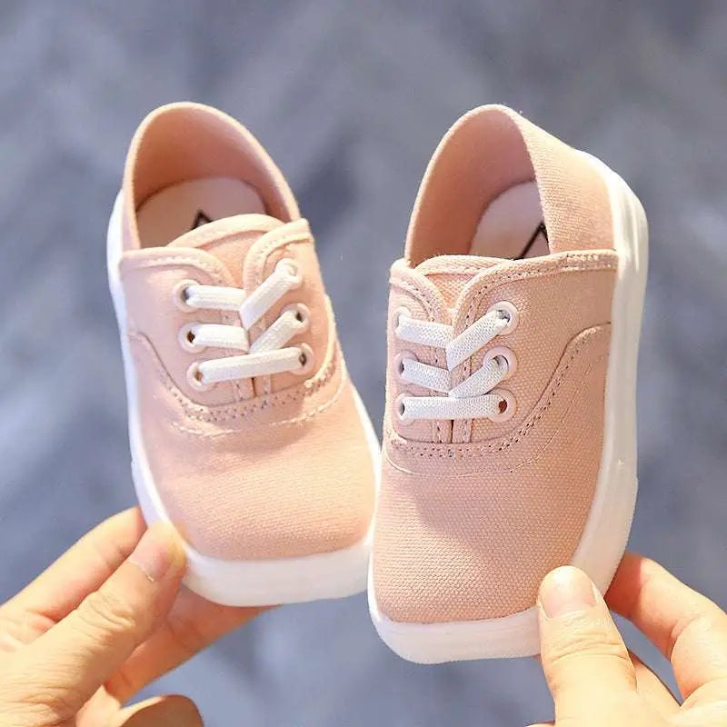 Pair of toddler canvas shoes korean board in blush pink with white laces and thick white rubber sole