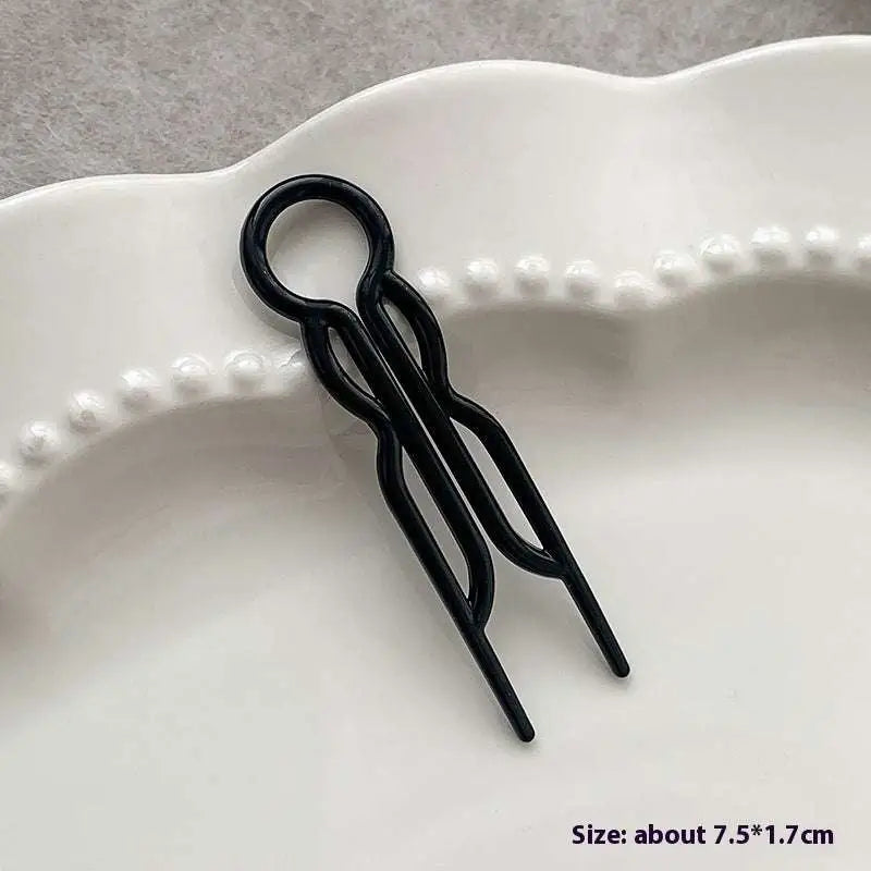 Black metal lazy updo gadget hair clip with sleek twisted design and circular top loop for bun lazy styling