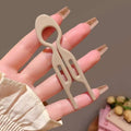 Beige plastic sim card ejector tool with sleek minimalist design for tortoiseshell bun lazy updo gadget styling