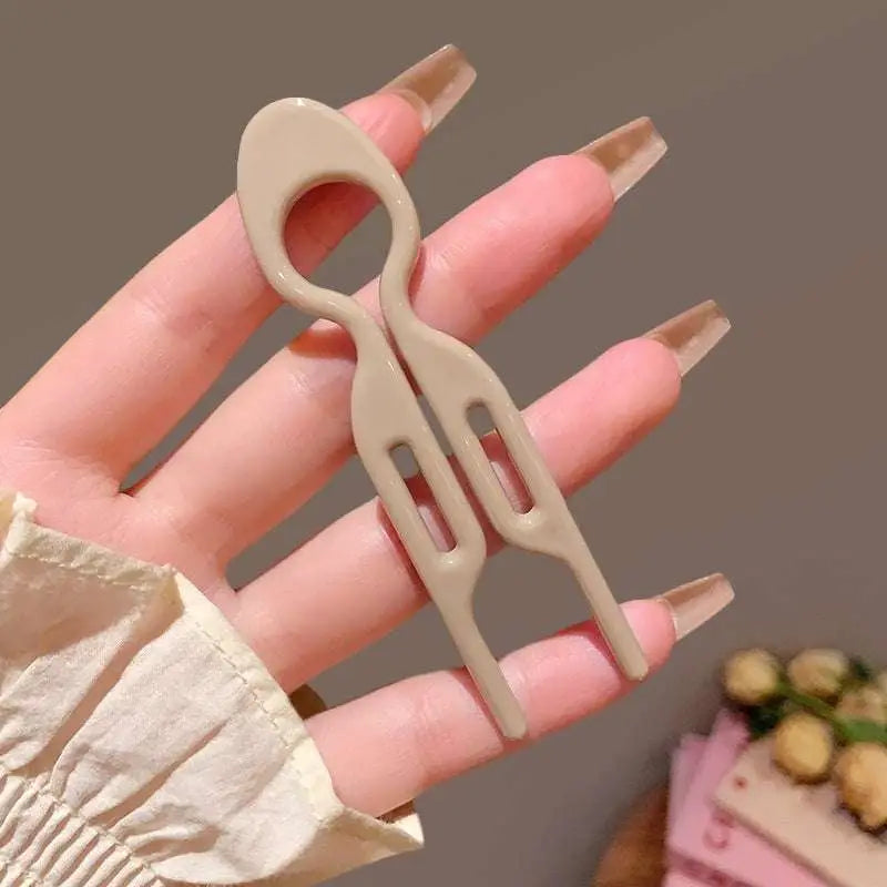 Beige plastic sim card ejector tool with sleek minimalist design for tortoiseshell bun lazy updo gadget styling
