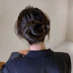 A sleek translucent black tortoiseshell bun lazy updo gadget hair clip with modern oval design holding a dark brown bun