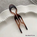 A sleek tortoiseshell plastic lazy updo gadget hair comb with two prongs for easy bun lazy styling