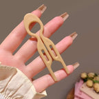 Beige plastic sim card removal tool with looped handle and two prongs for tortoiseshell bun lazy updo gadget styling