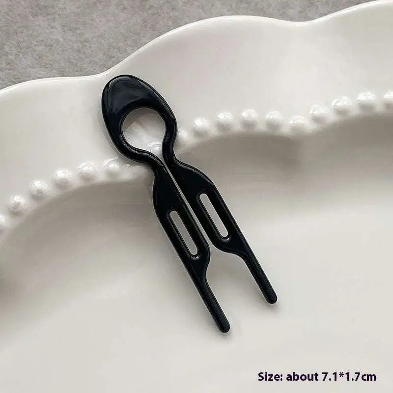 Black plastic lazy updo gadget hair clip with sleek modern design two prongs and oval handle for bun lazy styling