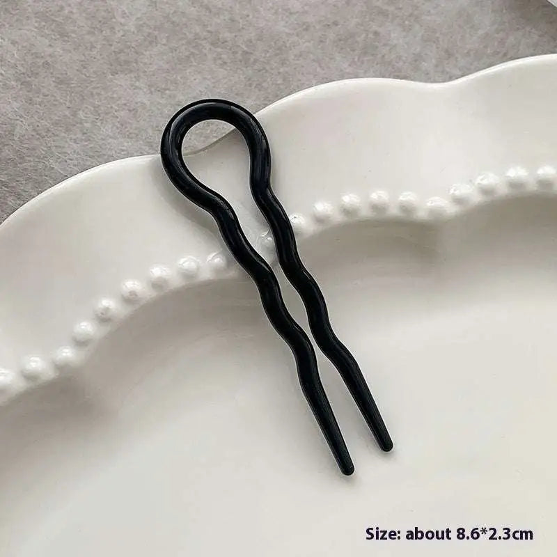 Black wavy hair pin with a glossy finish for tortoiseshell bun lazy and bun lazy styling updos using a lazy updo gadget