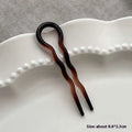 A sleek wavy two-pronged tortoiseshell bun lazy updo gadget hair clip for easy bun lazy styling