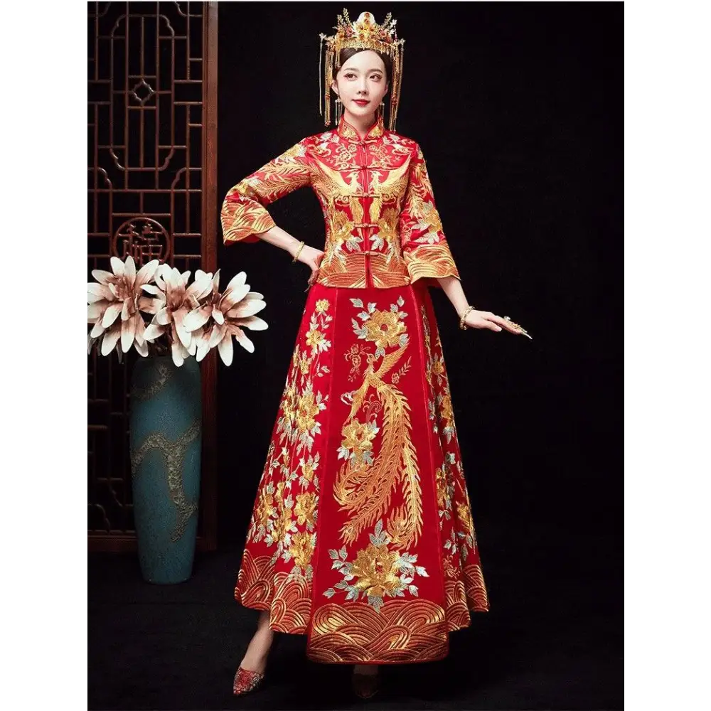 A woman wears a vibrant red robes xiuhe traditional chinese dragon wedding gown with intricate golden embroidery and headpiece