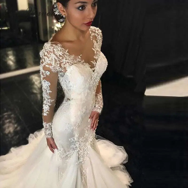 Trailing white temperament long lace wedding dress in white with fitted bodice and long sleeves mermaid silhouette