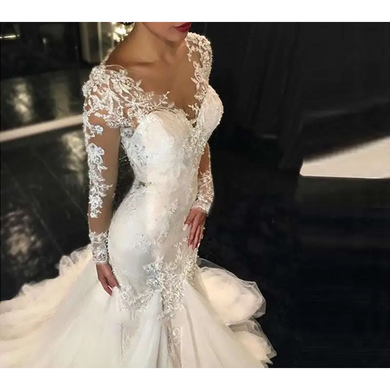White mermaid-style long lace wedding dress with intricate lace detailing and long sheer sleeves trailing white temperament