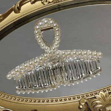 Clear acrylic pearl grab clip with white pearls and a rhinestone bow decoration for elegant hair styling