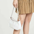 Trendy small crocodile white leather shoulder bag with contrasting black trim and chunky off-white acrylic chain strap
