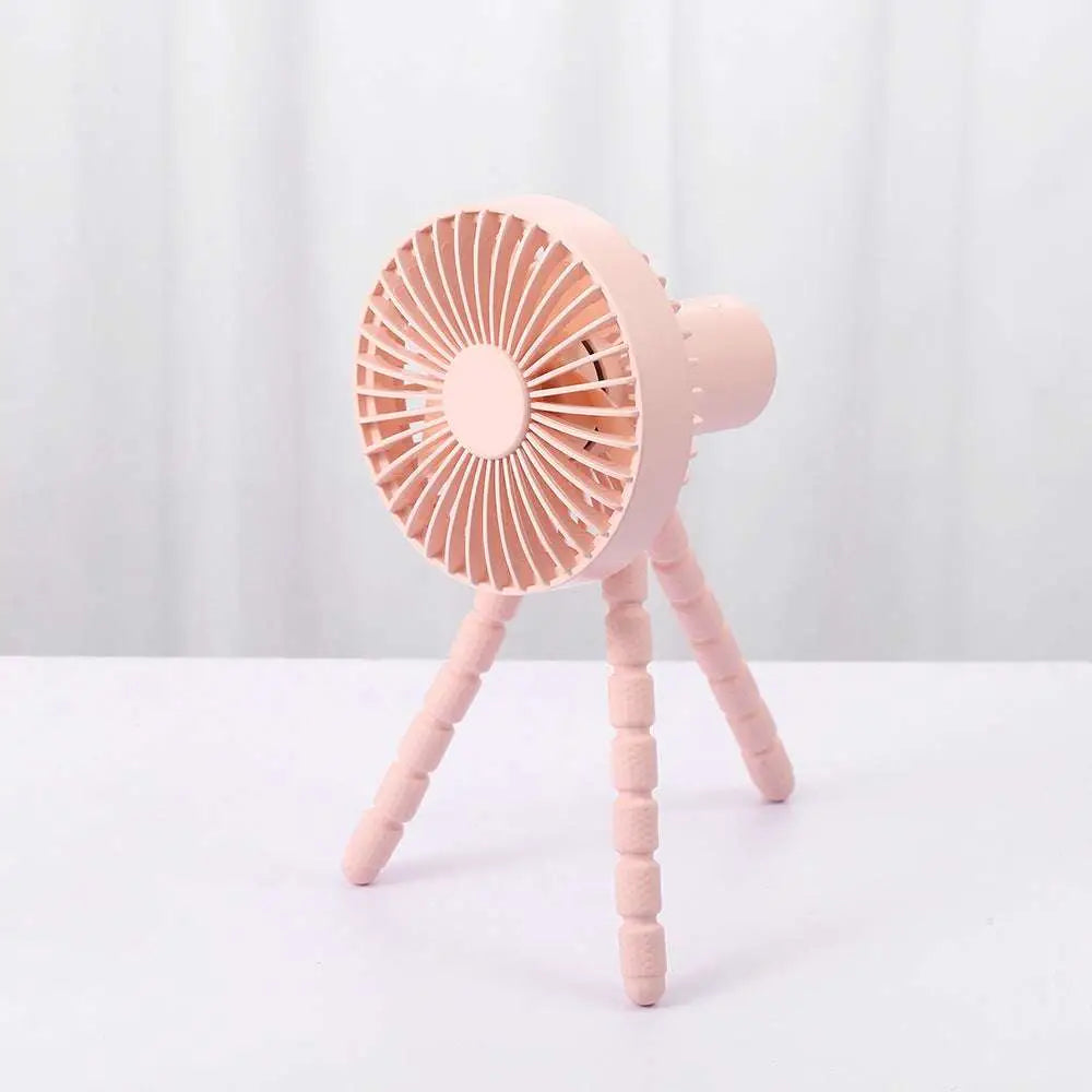 Pink plastic tripod small fan with circular grille and segmented legs desktop multifunctional adjustable design