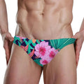 Tropical floral sexy bikini swimsuit briefs with vibrant pink hibiscus and teal leaves on deep navy fabric, hand wash recommended