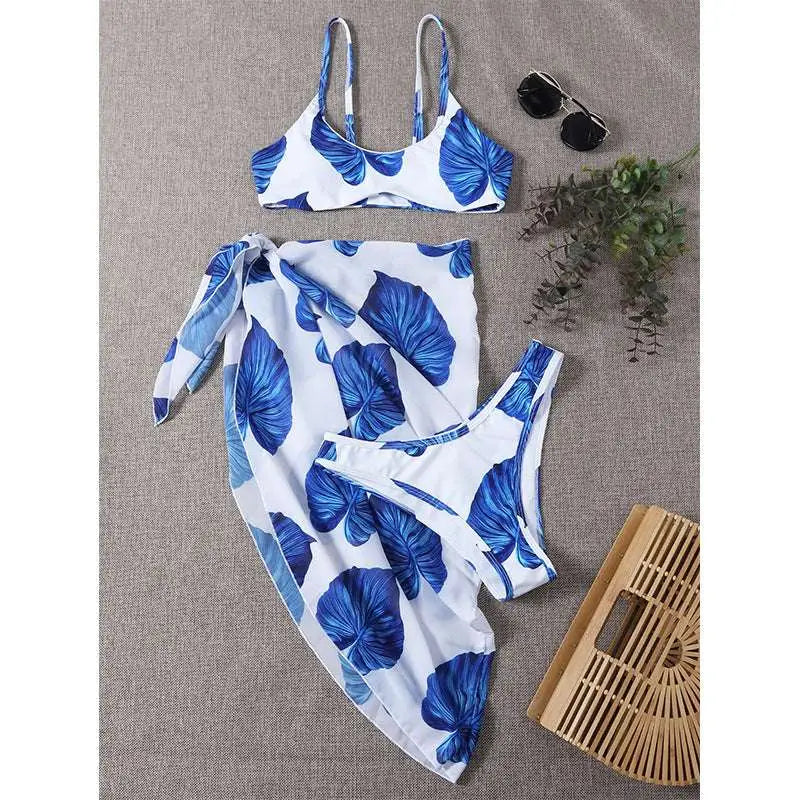 White and blue tropical leaf bikini printed three-piece set swimsuit with matching wrap skirt for beachwear
