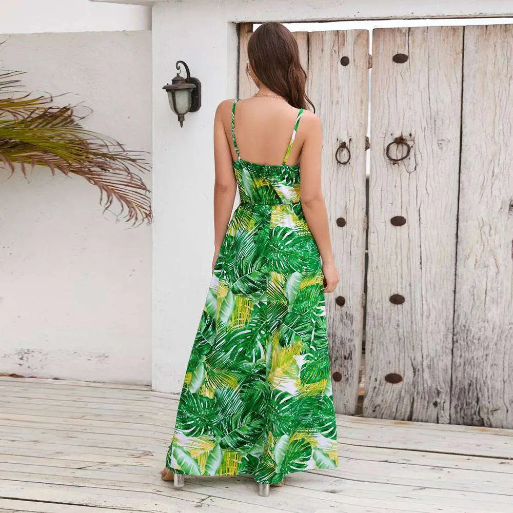 A vibrant green and yellow tropical leaf print summer swing dress with thin spaghetti straps for warm weather