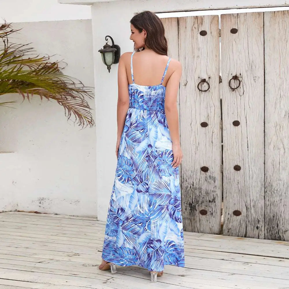 Blue and white tropical leaf print summer swing dress with thin spaghetti straps and flowing maxi silhouette