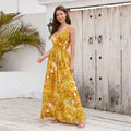 A vibrant yellow summer swing dress with tropical leaf print and spaghetti straps featuring a flattering v neckline