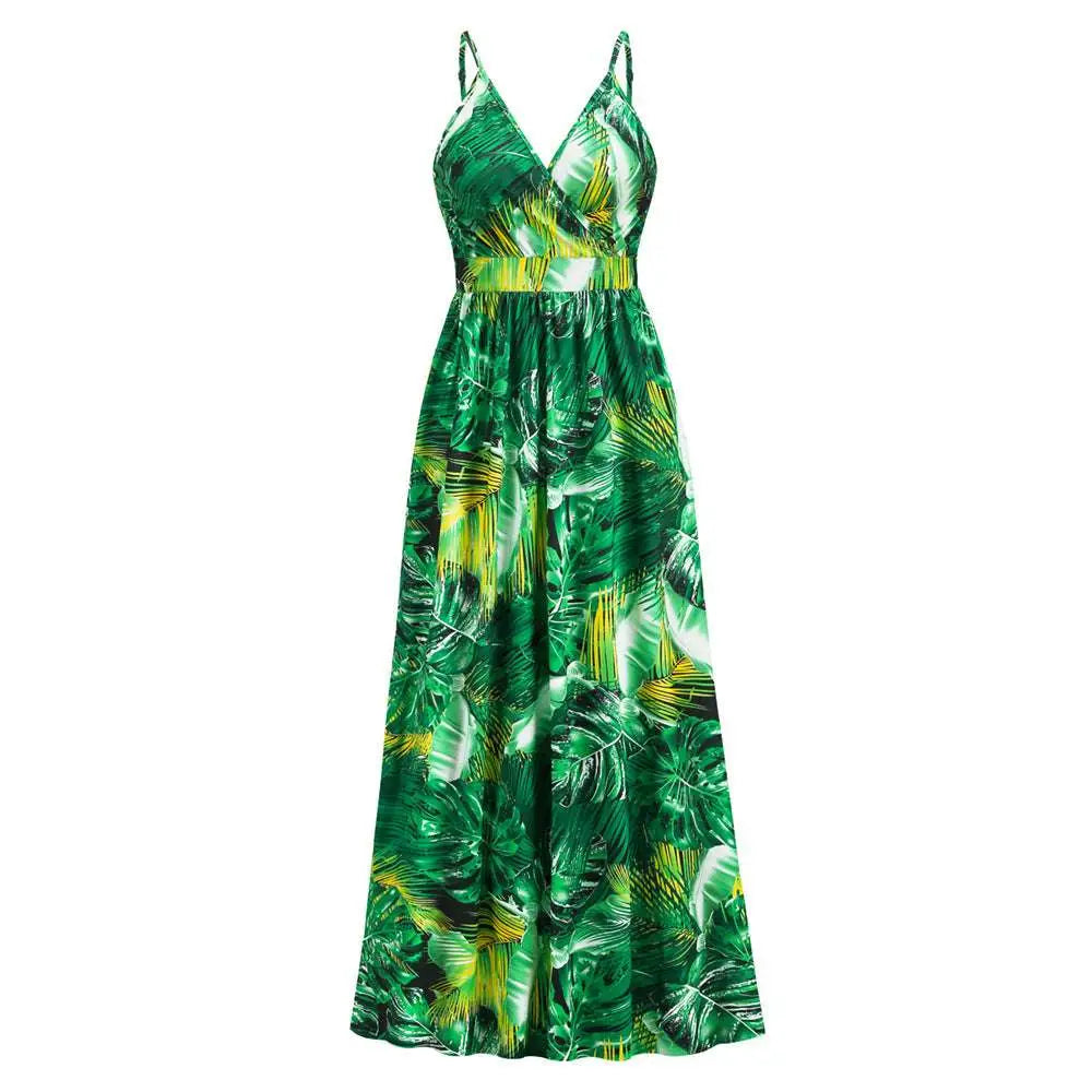 A vibrant green and yellow tropical leaf print summer swing dress with thin spaghetti straps and a maxi length