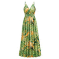 A vibrant green and yellow tropical leaf print summer swing dress with thin spaghetti straps perfect for warm weather