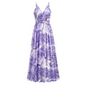 A flowing purple and white tropical leaf print summer swing dress with thin spaghetti straps for warm weather