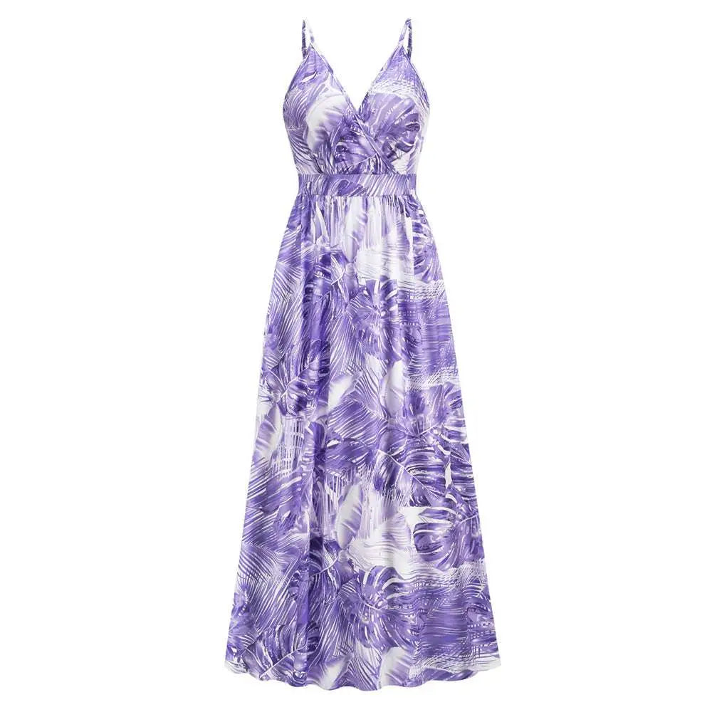 A flowing purple and white tropical leaf print summer swing dress with thin spaghetti straps for warm weather