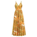 A flowing summer swing dress with tropical leaf print in orange gold and white featuring spaghetti straps