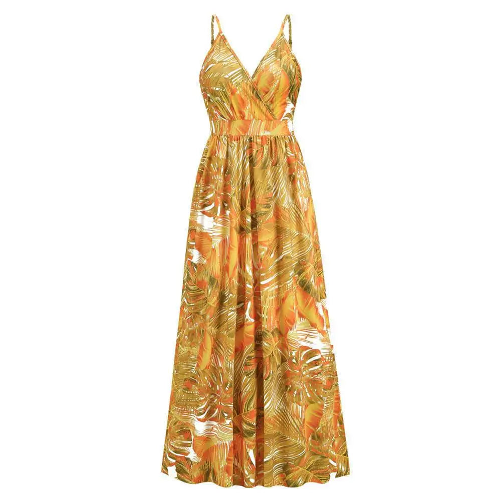 A flowing summer swing dress with tropical leaf print in orange gold and white featuring spaghetti straps