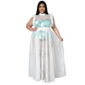 A plus size woman wears a fashionable temperament mesh white maxi dress with feathered shoulders and turquoise sequined bodice