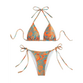 A vibrant tropical print orange thong bikini swimsuit with adjustable tie-side strings for a stylish beach look