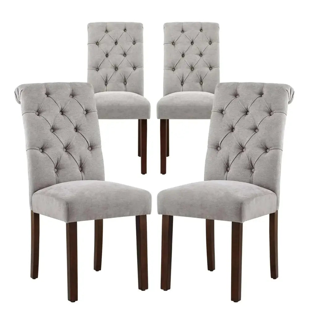 Set of four gray tufted fabric dining chairs with durable solid wood legs and linen-look fabric stretched upholstery