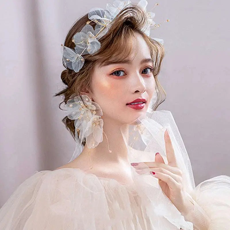 Delicate white tulle flower headband and earring set adorned with organza tulle flower and tiny gold accents