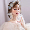 Delicate white tulle flower headband and earring set adorned with organza tulle flower and tiny gold accents