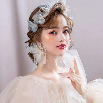 Delicate white tulle flower headband and earring set adorned with organza tulle flower and tiny gold accents