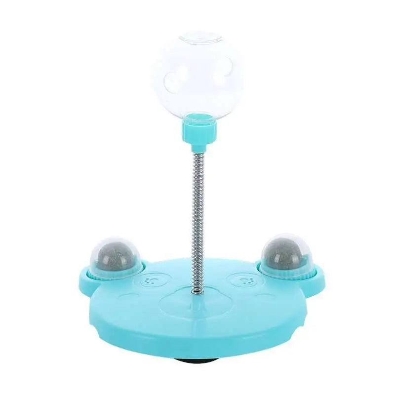 Light blue plastic tumbler feeder cat toy with clear glass dome and flexible metal spring stem for pet food dispensing