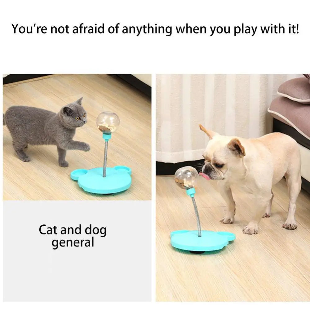 Light blue plastic tumbler feeder cat toy with clear spherical top and flexible metal stem for pet food dispensing