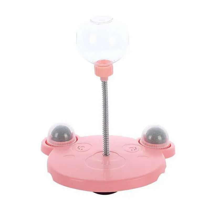 Pink plastic cat-shaped tumbler feeder cat toy with clear dome and silver spring stem pet food dispenser