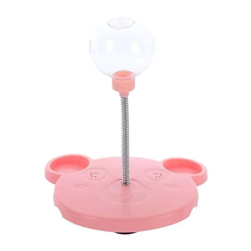 Pink plastic bear-shaped tumbler feeder cat toy with clear spherical water bottle and flexible metal stem dispenser