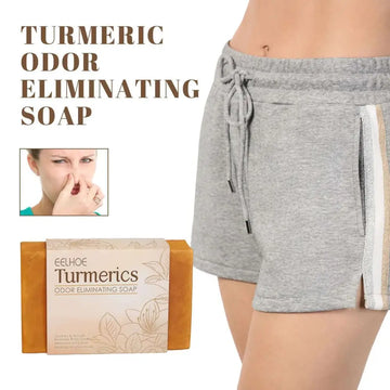 A rectangular bar of orange eelhoe turmeric cleansing soap in beige wrapper with leaf illustrations for odor elimination