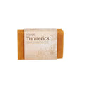 A rectangular orange turmeric cleansing soap bar wrapped in beige floral paper labeled eelhoe for odor elimination and brightening