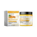 Yellow jar of turmeric exfoliating facial scrub with black lid and matching box for dark spot fading