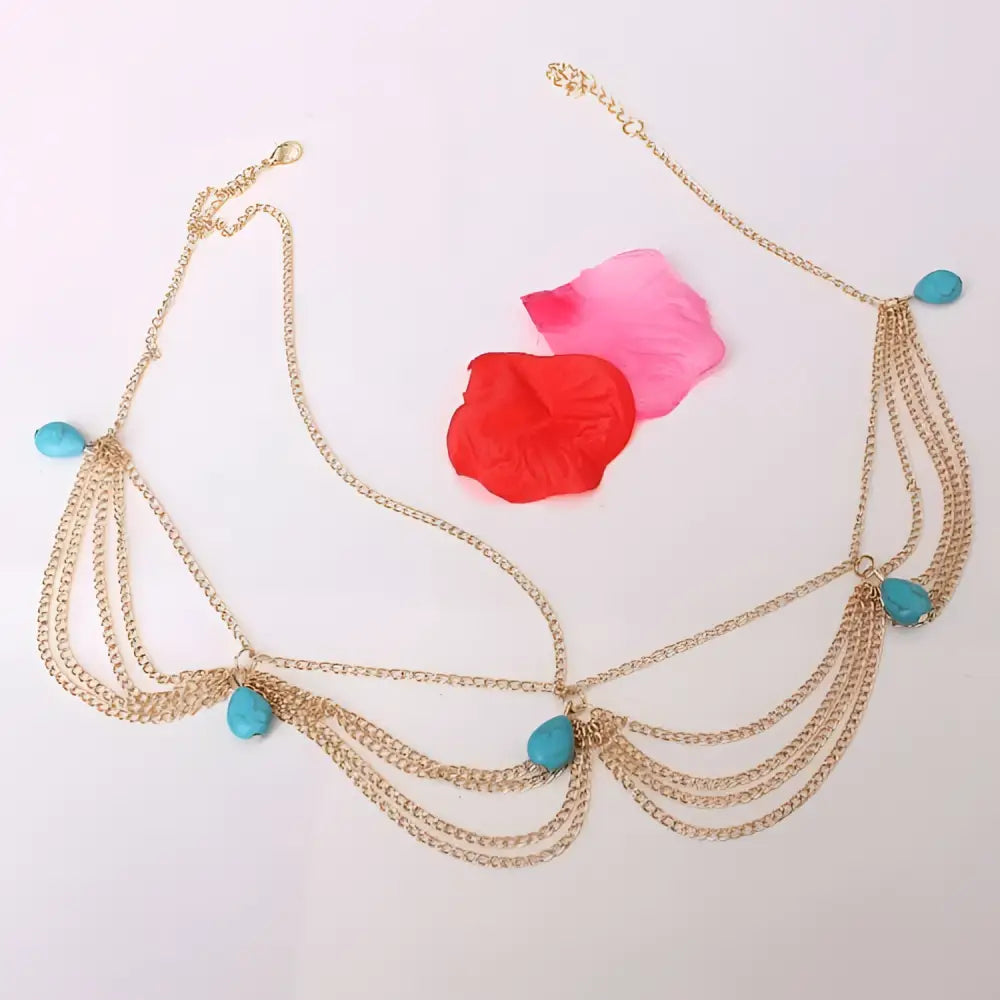 Gold-toned chain tasseled headband adorned with turquoise teardrop beads in an ethnic style design