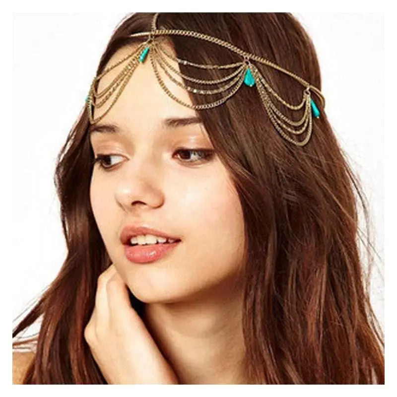 Turquoise ethnic style tasseled headband adorned with turquoise teardrop beads and delicate gold-toned chain tassels
