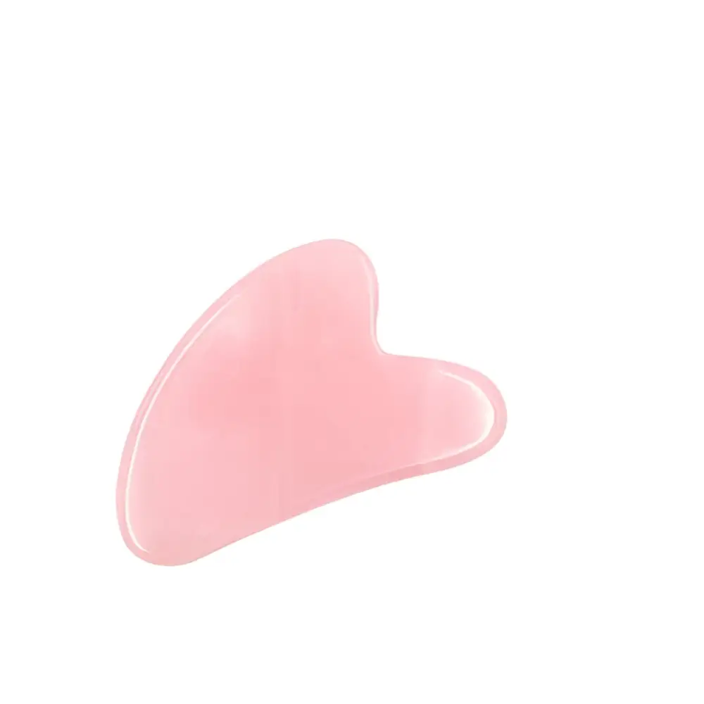 A smooth translucent pink jade gua sha tool with heart design for neck massager massage and massager massage relieve