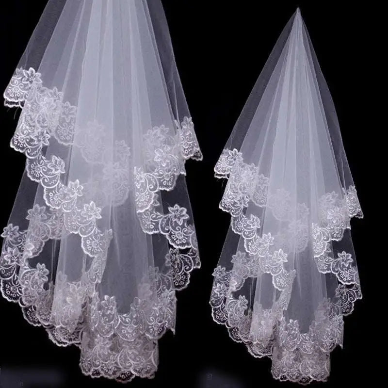 Two elegant white bridal veil lace headdresses featuring intricate floral embroidery on layered edges