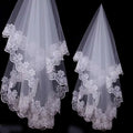 Two elegant white bridal veil lace headdresses with intricate floral embroidery along layered edges