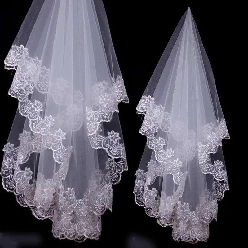 Two elegant white bridal veil lace headdresses with intricate floral embroidery along layered edges