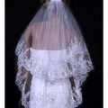 A delicate white two layer bridal sequined polyester veil with intricate beaded lace embroidery and scalloped edges