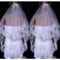A delicate white two layer bridal sequined polyester veil with intricate lace and flowing sheer design